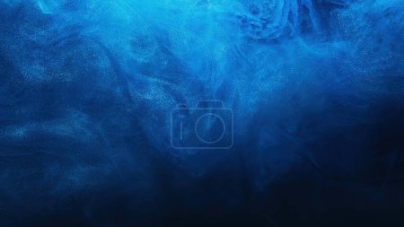 Foto de Brillo niebla fondo abstracto. Salpicadura de agua de tinta. Ola de niebla. Color azul brillante partículas de polvo brillante textura nube de vapor flotando en negro oscuro. - Imagen libre de derechos