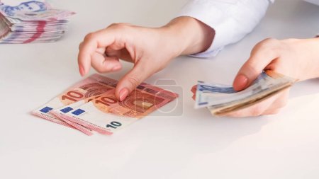 Photo for Currency exchange. Money value. Global economy. Financial inflation. Closeup of business woman hands counting Euro cash paper banknotes. - Royalty Free Image