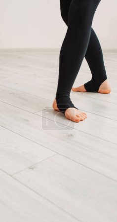 Photo for Ballet dancer. Choreography class. Unrecognizable graceful elegant woman legs practicing working out position performance rehearsal in studio. - Royalty Free Image