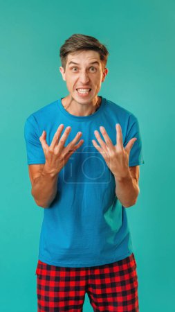 Photo for Rage man. Overwhelming aggression. Emotional angry guy clenched teeth expressing hate anger isolated on turquoise empty space background. - Royalty Free Image