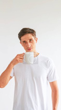 Photo for Morning coffee. Wake up habit. Confident pleased attractive man holding cup enjoying hot beverage isolated on white empty space background. - Royalty Free Image