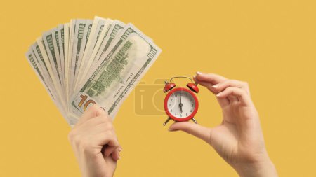 Photo for Money time. Financial crisis. Woman hands with holding dollar fan and alarm clock on yellow background. - Royalty Free Image