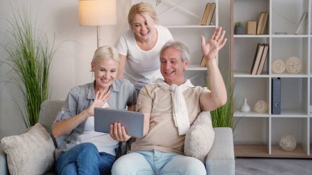 Photo for Online call. Happy family. Distance communication. Joyful mother father and daughter having virtual conference on tablet computer light home interior. - Royalty Free Image