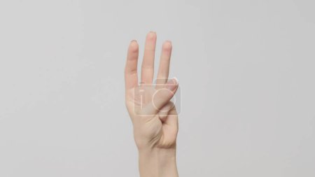 Photo for Hand gesture. Three number. Woman showing trio fingers up on light gray background. - Royalty Free Image