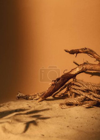 Photo for Nature showcase. Sand arrangement. Product placement. Brown dry tree wood bark rope pile leaf shade on sunny orange abstract background with copy space. - Royalty Free Image