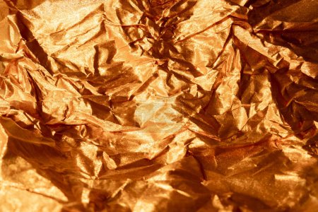 Photo for Creased foil texture metallic background. Crumpled overlay. Golden shiny shimmering distressed wrinkled film abstract surface with free space. - Royalty Free Image