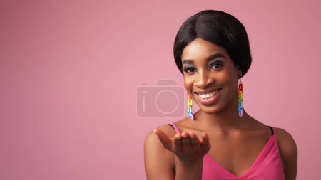 Photo for Welcome gesture. Cheerful face. Advertising portrait. Happy woman with beautiful toothy smile hand open palm isolated on pink color empty space background. - Royalty Free Image