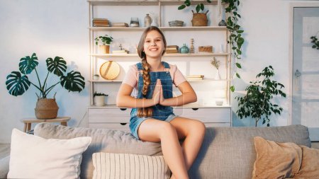 Photo for Child blog. Online stream. Confident happy emotional smiling smart girl talking gesticulating sharing ideas for vlog content on sofa at home. - Royalty Free Image