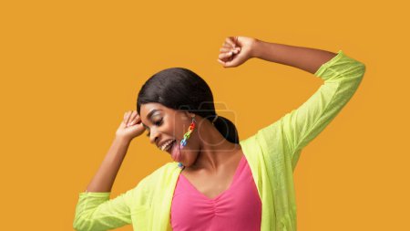 Photo for Happy dance. Fun joy. Positive lifestyle. Excited amused carefree smiling woman enjoying freedom luck isolated on bright orange color empty space background. - Royalty Free Image