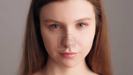 Photo for Pure skin. Female cosmetic. Beauty care. Young fresh woman with nude makeup glowing radiant moisturized hydrated nourished face isolated on beige. - Royalty Free Image