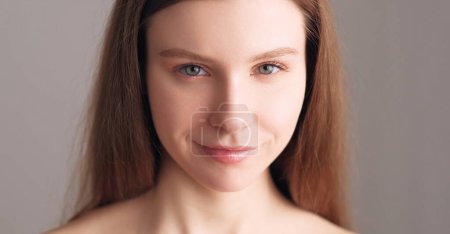 Photo for Perfect skin. Face wellness. Beautiful flowless confident smiling fair hair woman with natural makeup nude eyeshadow and lipstick isolated on beige. - Royalty Free Image