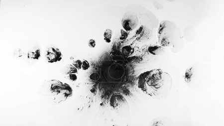 Photo for Dirty stains. Smearing spots. Abstract black splashes grain spots spreading on white free space background grunge illustration. - Royalty Free Image