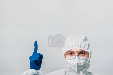 Photo for Medical professional. Healthcare advertising. Important information. Doctor woman specialist in white ppe mask goggles pointing finger at empty space isolated on grey background. - Royalty Free Image