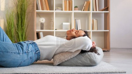 Photo for Home relax. Rest indoors. Lazy weekend. Peaceful serene cheerful woman lying on floor comfortable cushions at cozy living room. - Royalty Free Image