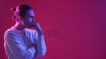 Photo for Pensive guy. Neon light people. Idea contemplation. Blue pink confused puzzled man thinking on purple color gradient empty space background. - Royalty Free Image