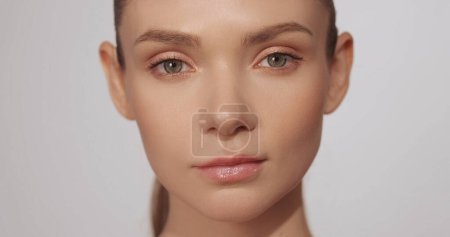 Photo for Beauty face. Skincare cosmetology. Facial freshness. Confident female model woman with natural makeup perfect flawless skin isolated on beige background. - Royalty Free Image
