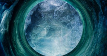 Photo for Mist swirl. Glitter smoke. Occult wheel. Shiny blue green color steam cloud in circle frame vortex abstract background with free space. - Royalty Free Image