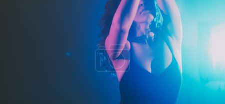 Photo for Dance energy performance. Graceful woman. Sensual emotional lady moving in haze shadow projector blue light dark indigo background copy space. - Royalty Free Image