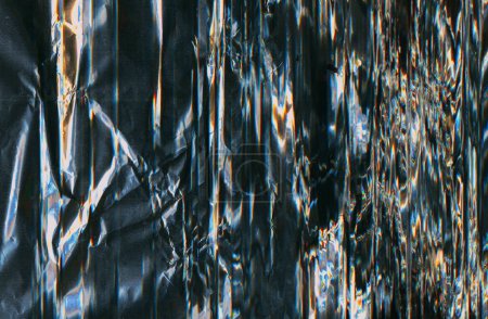 Photo for Crushed foil texture. Distressed overlay. Light flare noise. Blue orange white color glow dust scratches on glitched dark black illustration abstract background with free space. - Royalty Free Image