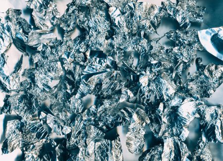 Photo for Crushed foil texture. Shiny abstract background. Light flare. Silver blue orange white color noise surface illustration wallpaper with free space. - Royalty Free Image