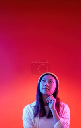 Photo for Thinking process. Problem solving. Young pensive serious preoccupied uncertain woman hand on chin isolated on red gradient background empty space. - Royalty Free Image
