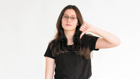 Dislike sign. Bad feedback. Reject no. Negative disapproval. Skeptic woman refusing with thumb down hand gesture isolated on white empty space background.