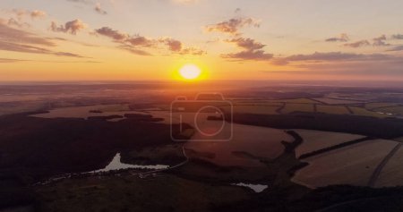 Photo for Aerial countryside view. Sunset landscape. Green field in red orange color sun light evening nature scenery skyline background drone shot. - Royalty Free Image