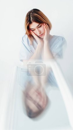 Photo for Mental disorder. Emotional suffer. Young sad depressed unhappy woman in apathy at distorted mirror reflection feeling anxiety on white background. - Royalty Free Image