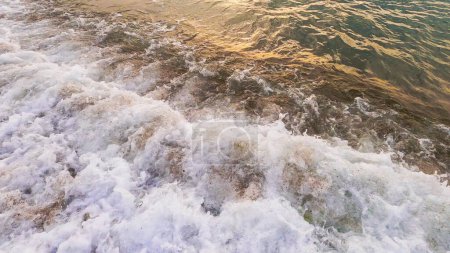 Photo for Coastline background. Ocean waves. Summer vacation. Clear sea water with white foam splash washing over brown sand beach marine landscape. - Royalty Free Image
