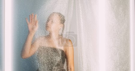 Photo for Plastic reuse. Ecology problem. Textured environmental protection waste reduction art of tender woman silhouette touching bubble wrap wall empty space. - Royalty Free Image
