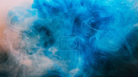 Photo for Glitter mist texture. Color smoke. Spiritual aura. Blue beige glowing shiny ink in water floating abstract art free space background. - Royalty Free Image