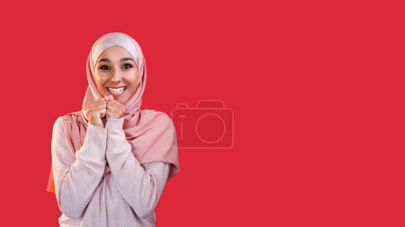 Photo for Exciting expectation. Wish inspiration. Good luck. Enthusiastic surprised happy woman in hijab isolated on red empty space background. - Royalty Free Image