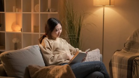 Photo for Book lover. Home rest. Literature hobby. Relaxed curious woman enjoying reading interesting novel on cozy couch room interior. - Royalty Free Image