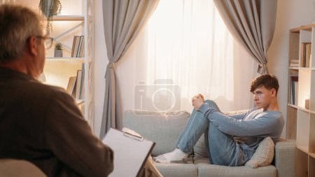 Photo for Counseling session. Psychology consultation. Depression treatment. Psychologist consulting upset man patient on couch at psychotherapy appointment. - Royalty Free Image