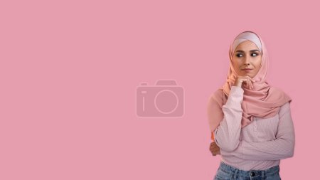 Photo for Curious woman. Advertising background. Pensive interested girl in hijab thinking considering offer isolated on pink empty space. - Royalty Free Image