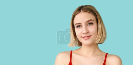 Peaceful smile. Optimistic expression. Lovely mood. Young charming woman enjoying life portrait isolated on blue empty space.