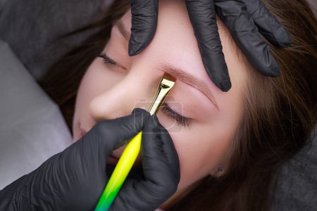 Photo for Correction of the shape of the markings applied with a brush before the permanent makeup procedure. PMU Procedure, Permanent Eyebrow Makeup. - Royalty Free Image