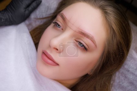 Photo for The model's eyebrows are sketched for permanent makeup. PMU Procedure, Permanent Eyebrow Makeup. - Royalty Free Image