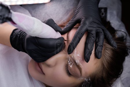 Permanent eyebrow makeup top view. PMU Procedure, Permanent Eyebrow Makeup.