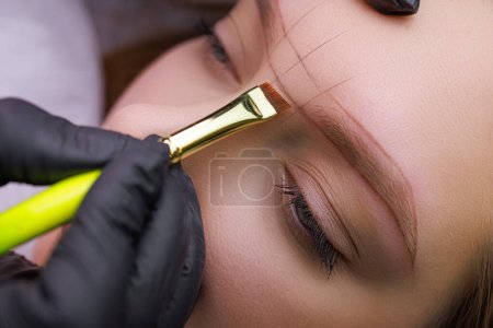 made sketch on the model's eyebrows before the permanent makeup procedure. PMU Procedure, Permanent Eyebrow Makeup.