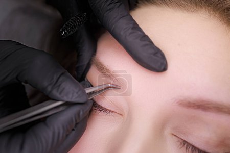 Photo for Macro photo of eyebrows which the master corrects before the procedure of permanent makeup. PMU Procedure, Permanent Eyebrow Makeup. - Royalty Free Image