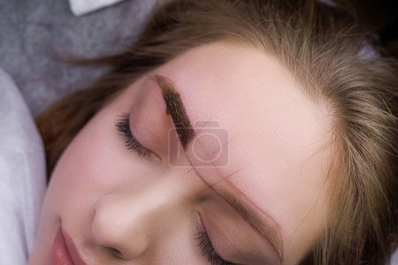 Macro photo of the eyebrow after the pigment has been applied to the skin. PMU Procedure, Permanent Eyebrow Makeup.