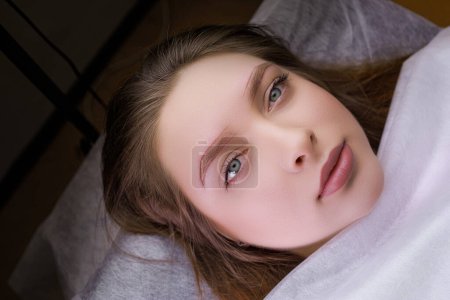 Photo for Cute girl model with markings on her eyebrows before permanent makeup procedure. PMU Procedure, Permanent Eyebrow Makeup. - Royalty Free Image