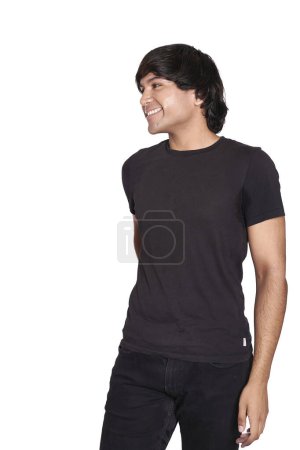 Photo for Young man in profile smiling, young latin boy dressed in black clothes, background is white. - Royalty Free Image