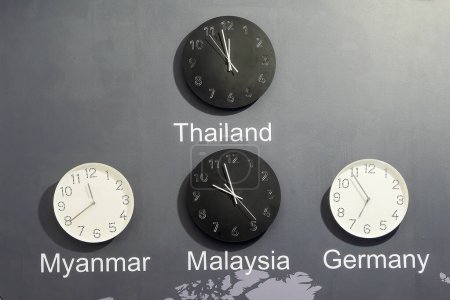 Photo for Clock of the difference time zone on the wall. Time of Thailand, Myanmar, Malaysia, Germany. - Royalty Free Image