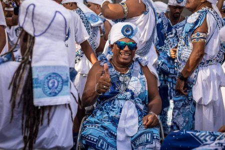 Photo for Salvador, Bahia, Brazil - February 11, 2018: Members of the traditional carnival block Filhos de Gandy parade in the streets of Salvador, Bahia during the 2018 carnival. - Royalty Free Image