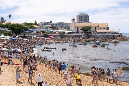 Photo for Salvador, Bahia, Brazil - February 02, 2023: Thousands of people are on the beach offering gifts to Yemanja on Rio Vermelho beach in Salvador. - Royalty Free Image