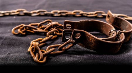 Old chains or handcuffs used to hold prisoners or slaves between 1600 and 1800.