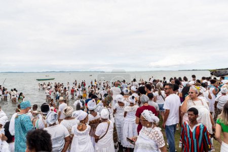 Photo for Santo Amaro, Bahia, Brazil - May 15, 2022: Hundreds of Candomble members are seen on Itapema beach during the Bembe do Mercado celebrations in the city of Santo Amaro. - Royalty Free Image
