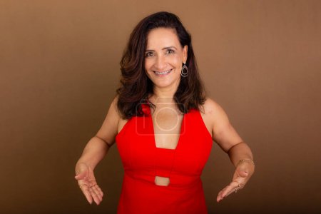 Photo for Portrait of beautiful confident cheerful woman making hand gestures. Motivating person. Isolated on brown background. - Royalty Free Image